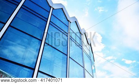 Abstract Closeup Of The Glass-clad Facade Of A Modern Building Covered In Reflective Plate Glass. Ar