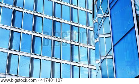Abstract Closeup Of The Glass-clad Facade Of A Modern Building Covered In Reflective Plate Glass. Ar