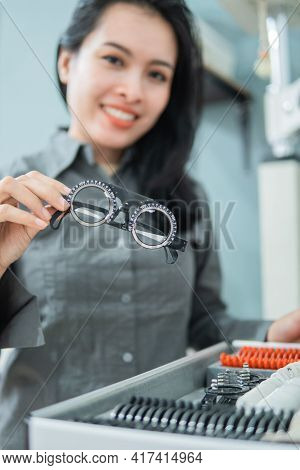 A Female Doctor Holding An Eye Test Measuring Aid In An Eye Clinic