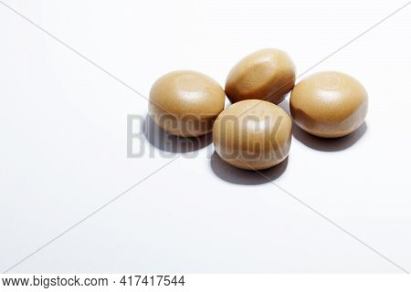 Four Pieces Of Chocolate Caramel On White Background