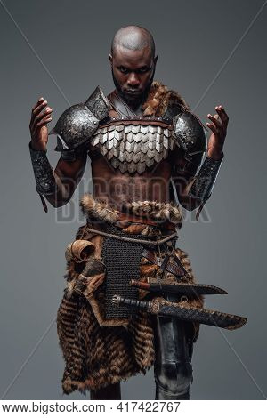 Authentic African Barbarian Prays With Raised Hands In Gray Background