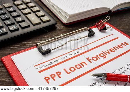 Ppp Loan Forgiveness Form And Red Notebook.