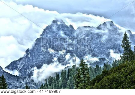 Wild Clouds Forming On Mountain Ridge Ready For Mountaineering Hiking With Valley With Wood Forest