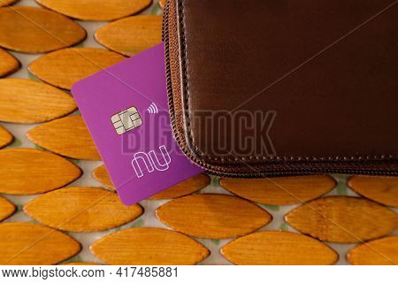 Minas Gerais, Brazil - January 19, 2021: Purple Credit Card With Nubank Logo And Leather Wallet. For