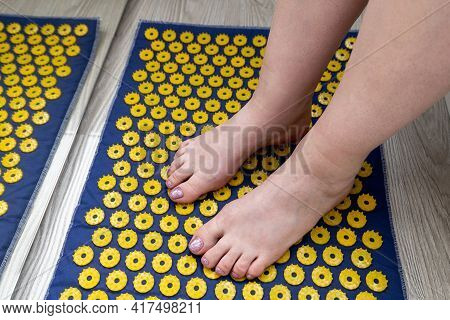 Womens Feet Stand On A Needle Mat - Foot Massage Using An Applicator Kuznetsov, Russia