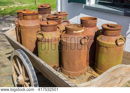 Old Rusty Milk Cans On A Wooden Cart In Historic Village Orvelte, Netherlands