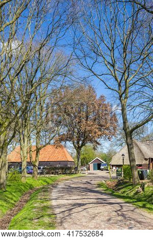 Orvelte, Netherlands - April 16, 2021: Cobblestoned Road Leading To An Old Farm In Orvelte, Netherla