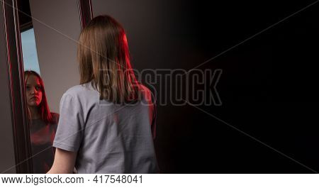 Young Woman Looking At Her Mirror Reflection With Grief. Unhappy Sad Person. Psychological Concept O