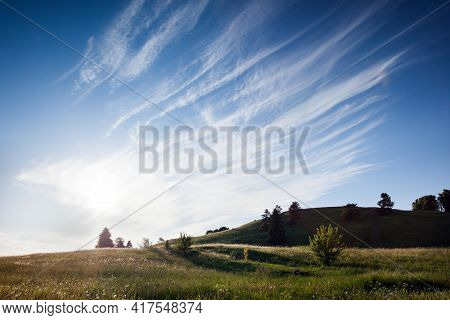 Lithuanian Landscape With A Delicate Feathered Filament Cloud Pauses For Thought Against A Luminesce