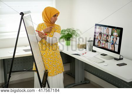 Arabic female teacher working with children online school during pandemic