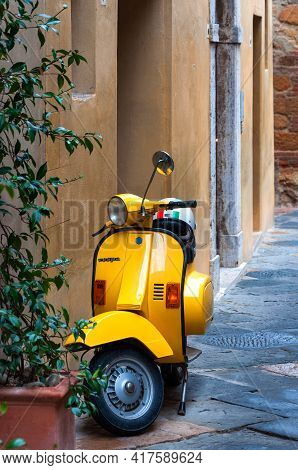 Pienza, Italy - October 13, 2017: Orange Vespa Parked On Old Cozy Street In Italy. Vespa On Narrow O