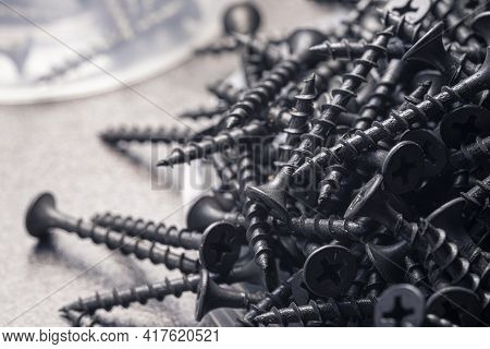 A Handful Of Self-tapping Screws For Wood. Construction Abstraction. Industrial Background.
