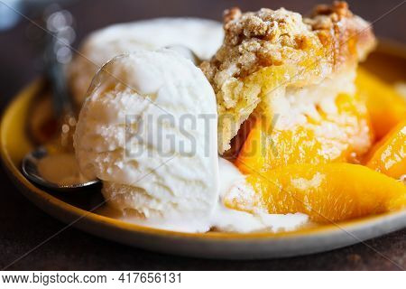 Abstract Of Freshly Baked Drop Biscuit Peach Cobbler With Melting Ice Cream. Selective Focus With Ex