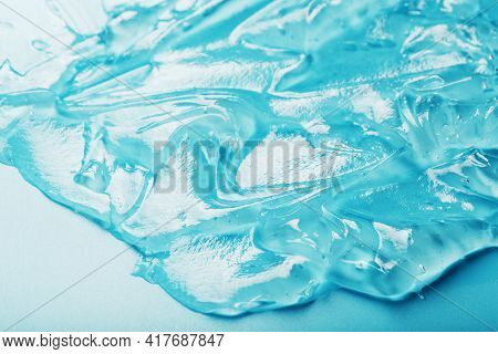 Gel With Hyaluronic Acid In The Form Of A Smear Of Glossy Texture On A Cyan Background.