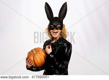 Smiling Woman In Black Bunny Mask With Pumpkin. 31 October. Sexy Girl In Halloween Costume With Jack