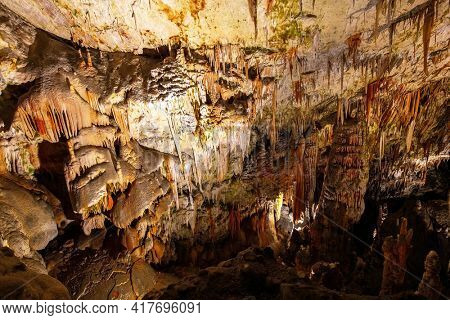 Postojna Cave. Fantastically lit underground palaces with stalactites and stalagmites. Magical places in Slovenia. Colossal system of underground caves in Slovenia. 