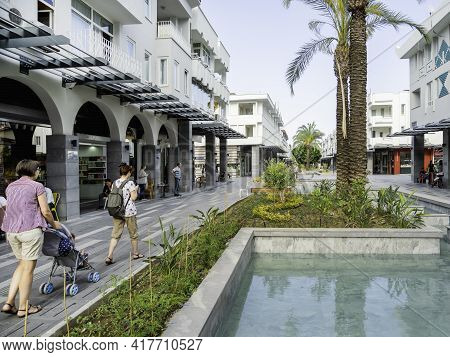 Kemer, Turkey - May 13, 2018. Tourists Walk Down Munir Ozkul Liman Street. Street With Modern Buildi