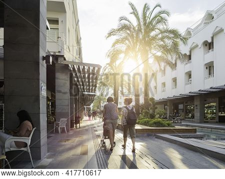 Kemer, Turkey - May 13, 2018. Tourists Walk Down Munir Ozkul Liman Street. Street With Modern Buildi