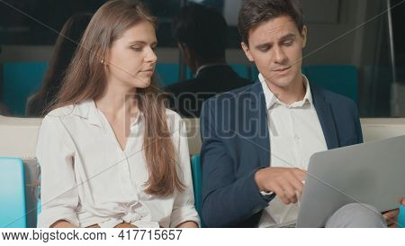 Young Caucasian White Business Woman And Man Sitting Using Laptop Computer Working Talking Together 