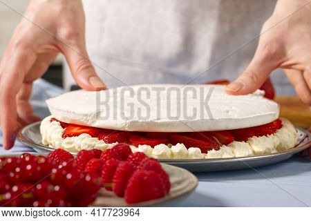 Woman Baker Add A New Layer Of Meringue Base In Strawberry Cake. Homemade Strawberries Cake Made Fro