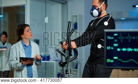 Performant Sportsman Measuring Heart Rate With Performant Ekg Equipment