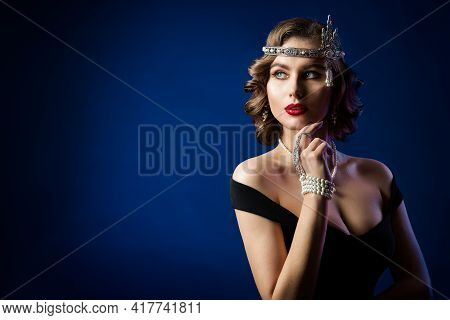 Retro Beauty Flapper Portrait, Woman Old Fashion Gatsby Hairstyle And Make Up, Blue Studio Backgroun