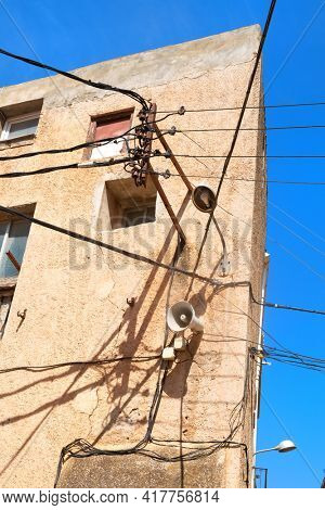 Typical electricity and electricity wires on old house in Spain