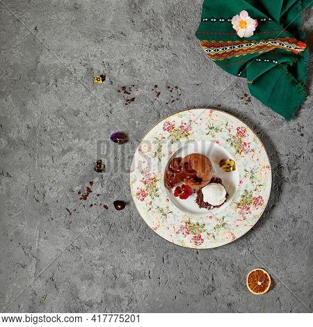 Chocolate Fondant - Chocolate Cakes with Liquid Centers served hot with ice cream. Molten Lava Chocolate Cake or Melting Chocolate on textured gray table. Top view