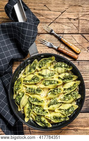 Jumbo Shells Pasta Conchiglioni Stuffed With Spinach And Cheese Baked With Sauce In A Pan. Wooden Ba