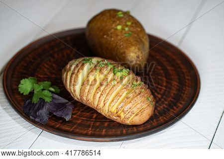 Baked Potatoes In The Skin On A Plate