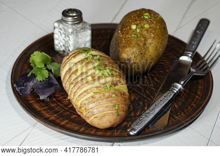 Baked Potatoes In The Skin On A Plate