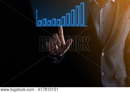 Business Man Holding Holographic Graphs And Stock Market Statistics Gain Profits. Concept Of Growth
