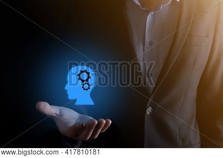 Businessman Man Holding A Man Icon With Gears In His Head. Artificial Intelligence. Technology Advan