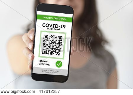 Unrecognizable Young Woman Showing On Her Smartphone Screen A Certificate Of Immunity Against Covid1