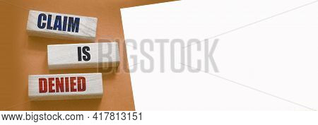 Claim Is Denied On Wooden Blocks On Brown Background With Copyspace. Business Financing Sponsorship 
