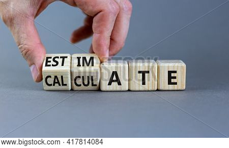 Estimate Or Calculate Symbol. Businessman Turns Wooden Cubes And Changes The Word 'calculate' To 'es
