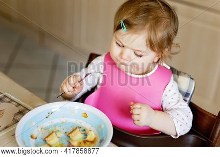Adorable Baby Girl Eating From Spoon Mashed Vegetables And Puree. Food, Child, Feeding And People Co