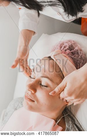 Happy And Relaxed Woman On Cosmetology Procedures, Massage And Applying Face Cream.