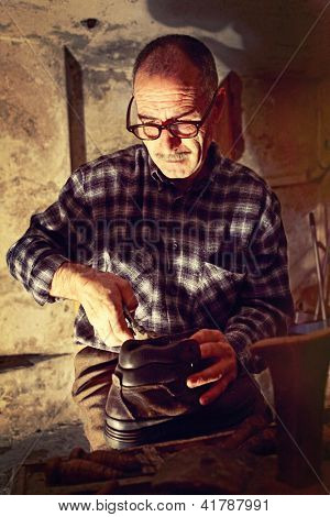 cobbler at work with old tools