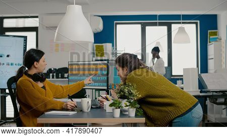 Graphic Designers Analysing Client Assets From Displays Checking Color Greading