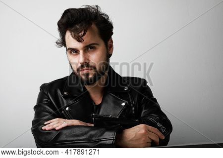 Handsome Biker Man Wearing Leather Jacker Posing Over White Background. Space For Text.