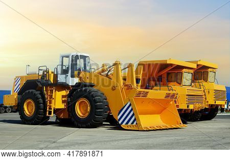Wheel Loader And Mining Truck. Heavy Construction Machinery And Mining Equipment. Front-end Loader O
