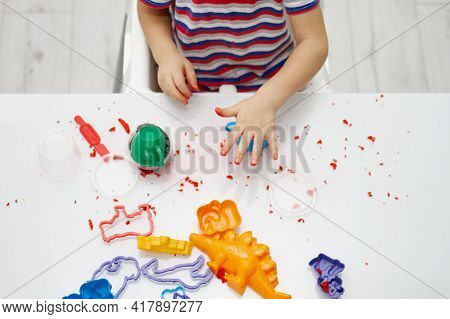A Childs Hands Play With Bright Kinetic Sand On A White Table. An Educational Game Of Kinetic Sand W