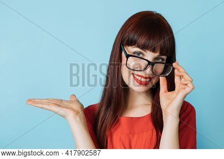 Portrait Of Beautiful Business Woman In Red Shirt And Eyglasses, Showing Imaginary Something, Empty 