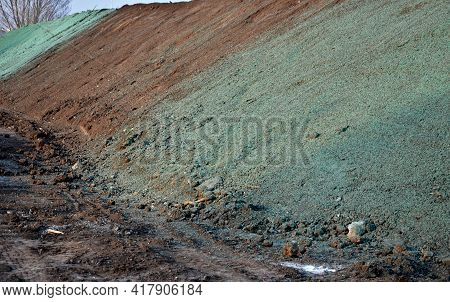 Stabilization Of Slopes By Hydro Sowing. A Mixture Of Wood Pulp And Green Grass Seed Is Sprayed From