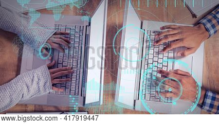 Composition of scope scanning with world map over man and woman typing on laptop keyboards. global technology and digital interface concept digitally generated image.
