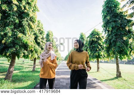 Two Muslim Teenage Girls In Veil Doing Outdoor Sports Together Just Before Breaking The Fast