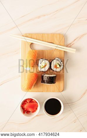 Sushi Salmon Set On Wooden Cutting Board Asian Food On Marble Background, Top View Flat Lay