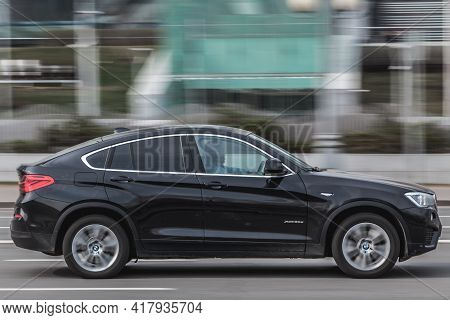 Moscow , Russia - April 2021: Fast Moving Black Bmw X4 In City Road. Compliance With Speed Limits On