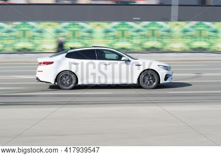 Moscow, Russia - March 2021: Kia K5 Dl3 On The City Road. Fast Moving White Shiny Korean Car On The 